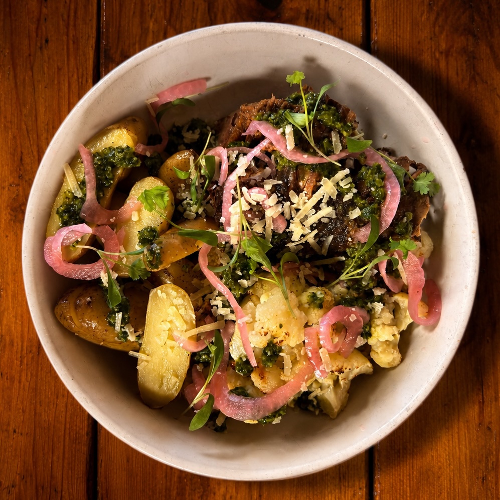Pulled beef brisket with potatoes, charred cauliflower, Manchego and chimichurri