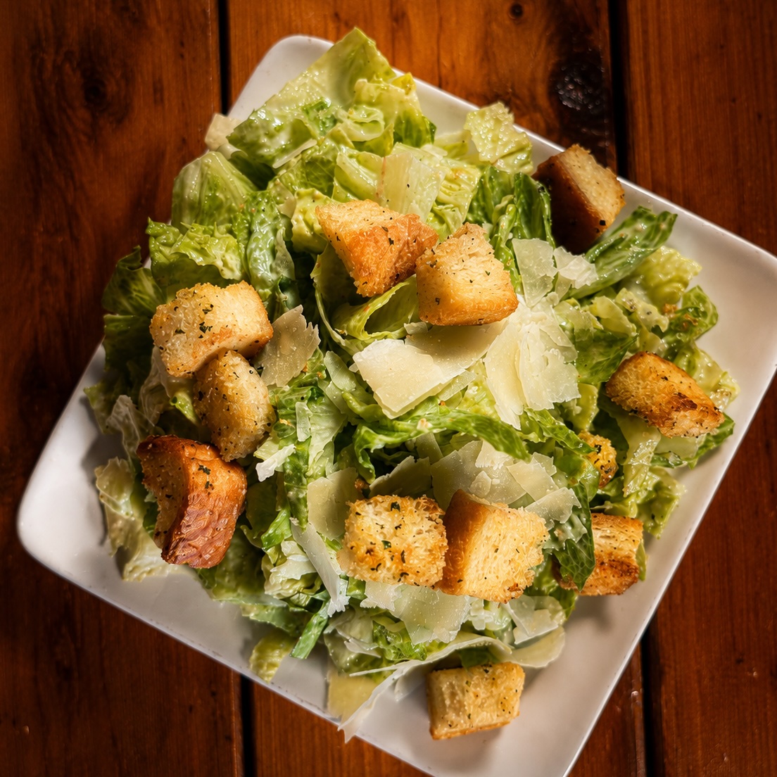 Small Caesar salad with romaine, garlic croutons and shaved parmesan