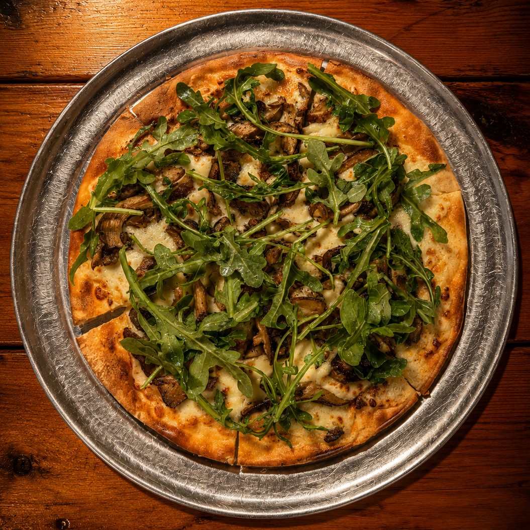 Wild mushroom flatbread with parmesan cream sauce, fontina, mozzarella and arugula